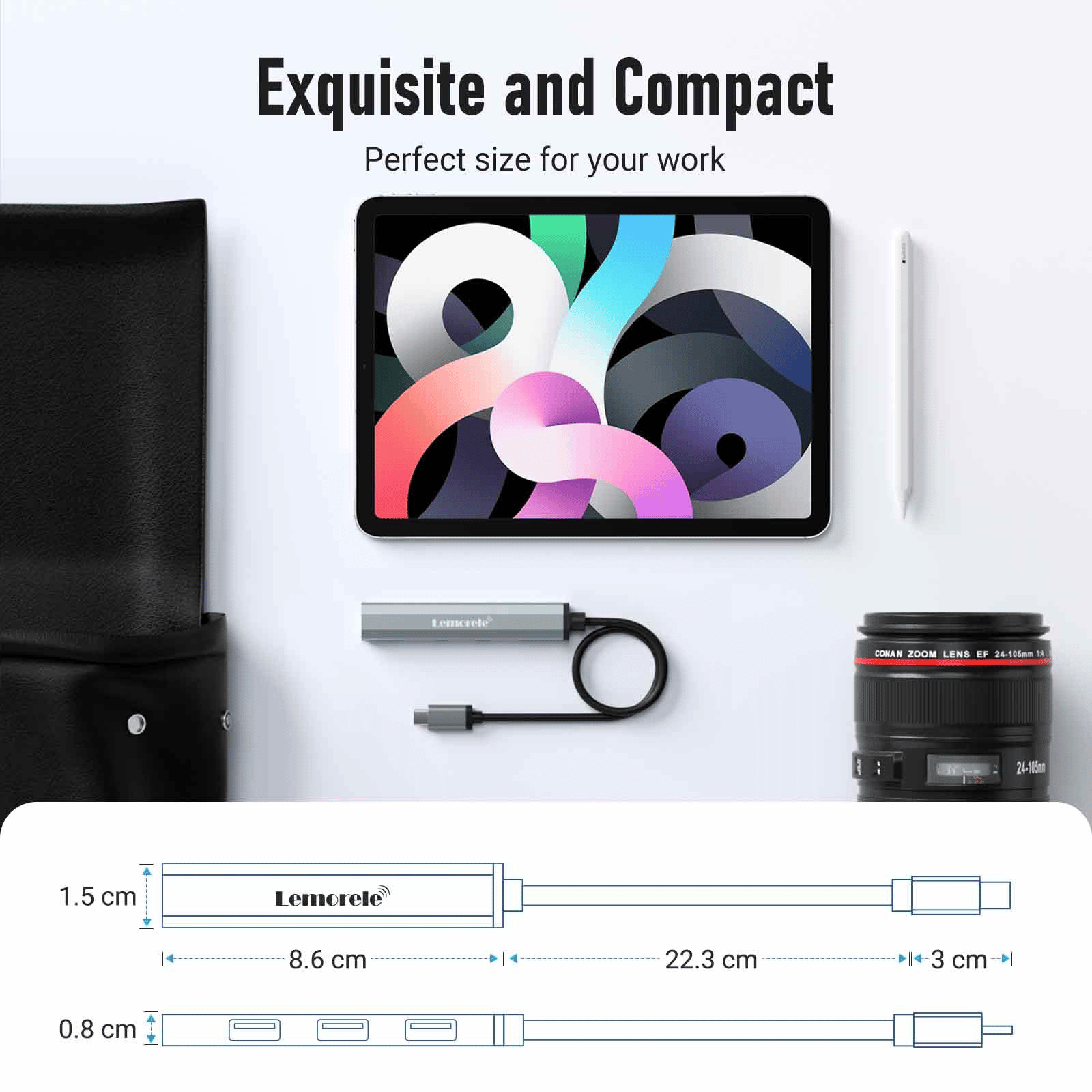 Top-down view of a tablet with a colorful abstract screen, surrounded by a camera lens, a USB-C cable, a stylus, and a black bag on a light desk.